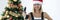 Smiling woman repairman in uniform and santa claus hat holding drill in hands near christmas tree