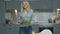 Smiling woman with salad in kitchen