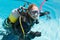 Smiling woman on scuba training in swimming pool