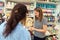 Smiling woman, seller in art shop, showing colorful vibrant watercolors in a palette with refills to a female customer