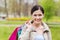 Smiling woman with shopping bags coming from sale