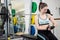 Smiling woman sitting on barbell bench