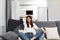 smiling woman sitting on the sofa with pillows comfortable apartment free time