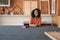 Smiling woman sitting at a table in her framing studio