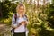 Smiling woman with smartphone during summer hike