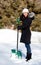 Smiling Woman with SNow Shovel