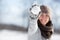 Smiling woman on a snowball fight competition, outdoor winter game with snow