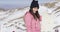 Smiling woman with snowboard in mountains