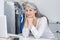 Smiling woman standing behind dry cleaning counter