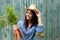 Smiling woman standing outside with bunch of carrots