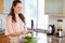 Smiling woman stirring salad