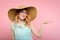 Smiling woman sunhat hold hand product advertising