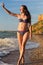 Smiling woman in swimsuit with polished sea glass