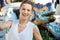 Smiling woman taking selfie near mosaic dragon in Park Guell