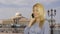 Smiling woman talking by mobile phone on background ship standing on parking lot