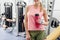 Smiling woman tasting beverage in fitness center