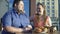 Smiling woman treating boyfriend french fries, fat couple date, unhealthy food