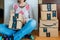 Smiling woman unboxing amazon cardboard boxes