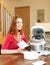 Smiling woman unpacking and reading user manual for new crock-pot