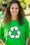 Smiling woman wearing green recycling t-shirt in park