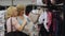 Smiling women doing shopping in clothes store