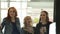 Smiling women in elegant clothes lift up new escalator