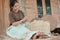 Smiling women holding bamboo slats to make woven bamboo