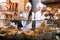 Smiling women selling fresh pastry and loaves