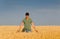 Smiling worker in barley field