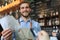 Smiling worker prepares orders at the bakery