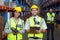 Smiling worker wearing yellow safety vest looking at camera