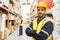 Smiling worker wearing yellow vest with arms crossed