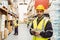 Smiling worker wearing yellow vest using handheld