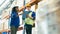 Smiling workers in distribution warehouse having a cheerful conversation