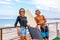 Smiling young active couple surfers relaxing on the beach after sport with Surfboard. Healthy Lifestyle. Extreme Water