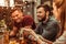 Smiling young-adult two men sitting at the bar table