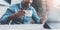 Smiling young African man making video conversation via digital tablet with business partners while drinking black