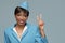 Smiling young african stewardess shows a positive gesture.