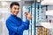 Smiling young asian man trying on new eyeglasses in the optical shop. Handsome man wearing new spectacles and looking at camera,