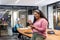 Smiling young biracial businesswoman using tablet pc while colleagues in background