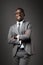 Smiling young black man with glasses and gray business suit