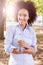 Smiling Young Black Woman Hold Bottle Of Water In Nature