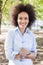 Smiling Young Black Woman Hold Bottle Of Water In Nature