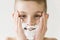 Smiling Young Boy Applying Shaving Cream to Face