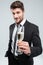 Smiling young businessman making cheers with glass of champagne