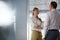 Smiling young businesswoman with male colleague in office