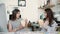 Smiling young businesswomen having lunch at table in office