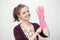 Smiling young caucasian girl woman with rubber gloves, sponge and sprayer, cleaning the house