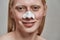 Smiling young caucasian man using nose pore strips