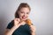 Smiling young Caucasian woman girl holding eating fried chicken  drumstick